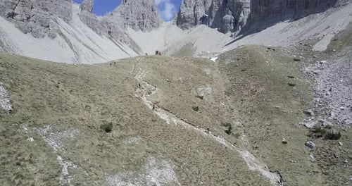 Aerial drone view of hikers hiking in the mountains.