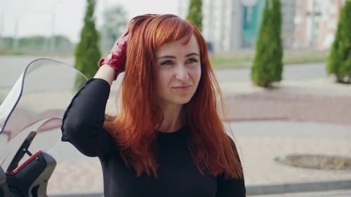 Woman with Red Hair on Red Motorcycle