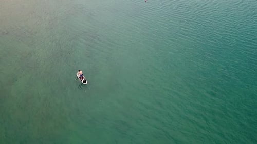 Aerial view of man practicing stands up paddle, Losinj, Croatia.