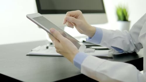 Doctor Using Tablet in Modern Office