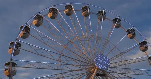 Ferris wheel in action againts a blue sky.