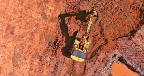 Excavator Loading Dirt into Dump Truck, Aerial