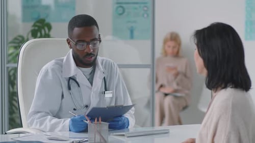 Doctor Consults With Patient in Modern Clinic
