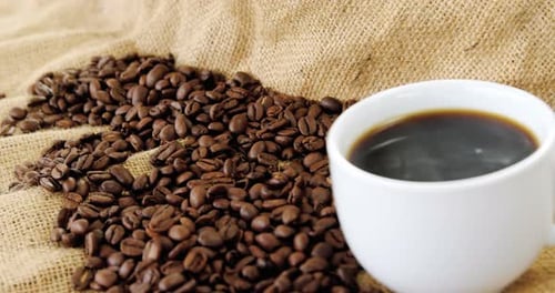 Cup of Coffee and Beans on Burlap