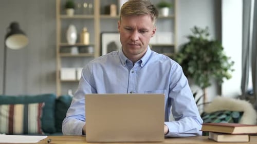Casual Businessman Closing Laptop Standing and Leaving Workplace