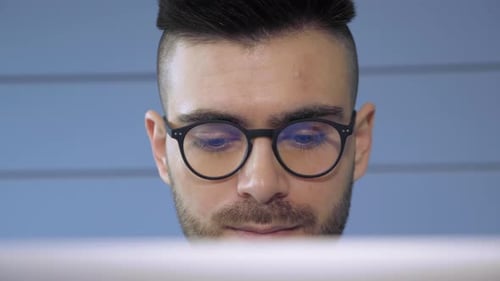 Man Wearing Glasses Looking at Computer Screen