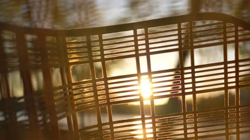 Close-up Bicycle with Basket Camera Movement From Top To Bottom, Sun Shines Through Holes