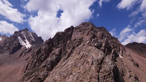 Hohe felsige Berge, die stellenweise mit Eis bedeckt sind
