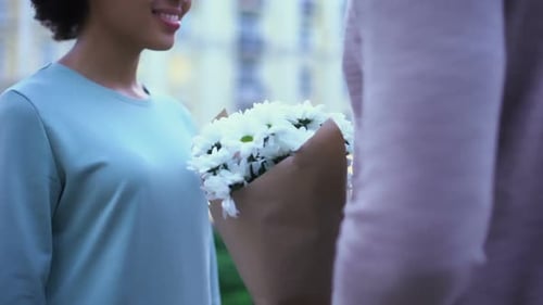 Loving Man Presenting Flowers to Pretty Girlfriend, Hugging on Summer Date City