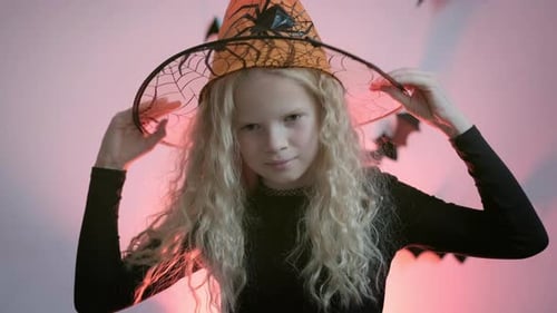 Smiling Girl Wearing a Witch Costume for Halloween