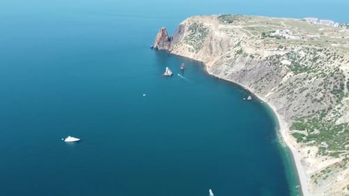 Aerial View From Above on Calm Azure Sea and Volcanic Rocky Shores