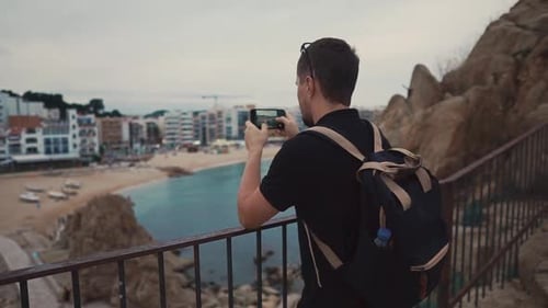 Guy Shooting Beach From Uphigh.
