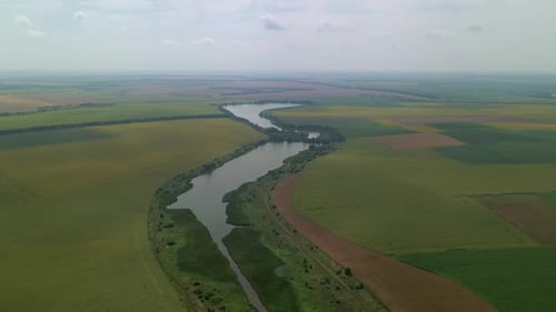 Drone Flies Above a Beautiful Summer Landscape with a River in Cloudy Day