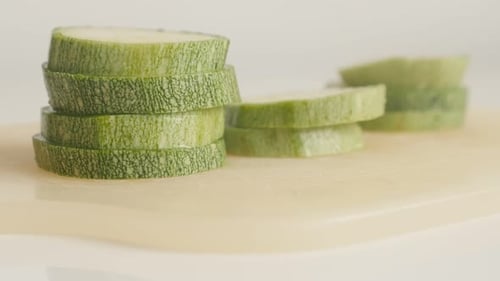 Pepo cylindrica vegetable on cutting board close-up 4K 2160p 30fps UltraHD tilting footage - Slices