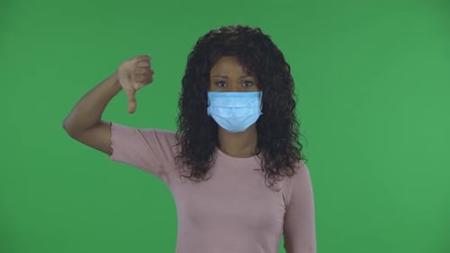 Woman Wearing Face Mask Gives Thumbs Down