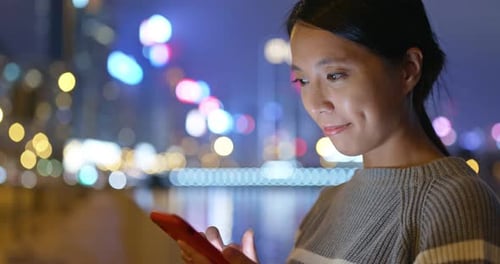 Woman use of mobile phone at night