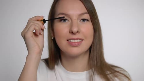 Woman Applying Mascara in Close-Up Beauty Shot