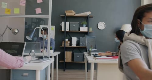 Zoomin of Men and Women Wearing Medical Masks Working in Office During Pandemic