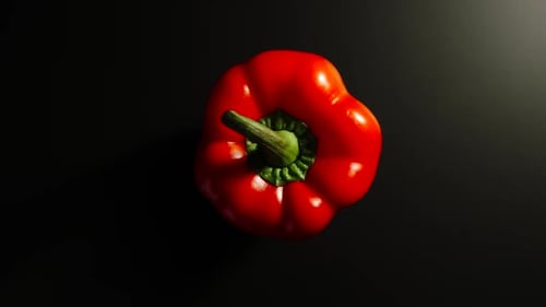Rotating Red Pepper on Dark Background, Close Up