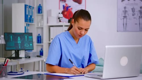 Female Doctor Working at Desk in Medical Office