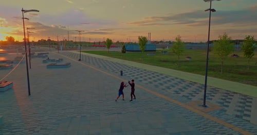Black Man is Training in Park Area of City in Sunset Time Aerial View on Two Sportsmen Prores