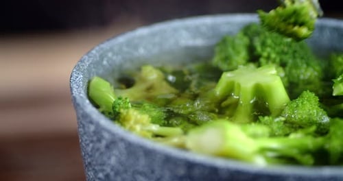 Fresh Broccoli Cooked in a Saucepan with Fork.