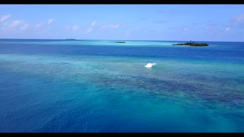 Aerial drone landscape of tropical coastline beach voyage by blue sea with white sandy background of