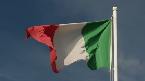 Italian Flag Waving Against Blue Sky