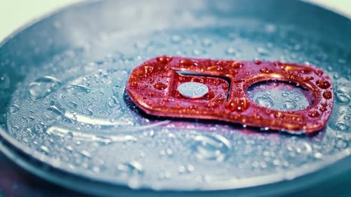 Aluminum Soda Tin Can Lid Cover of Soft Drink on Ice Goes Around the Circle