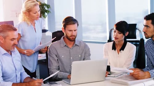 Team Working Together in Office on Laptop