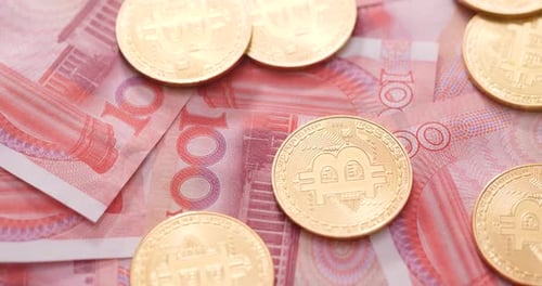 Bitcoin Coins on Chinese Yuan Banknotes