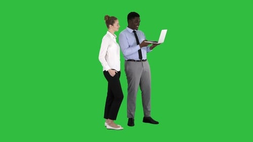 Business Colleagues Discussing Work on Laptop Over Green Screen