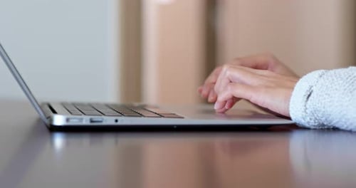 Hands Typing on Laptop Keyboard Close Up