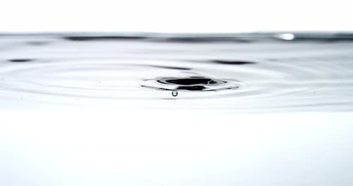Water Droplets Falling Onto Clear Surface