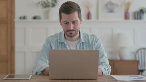 Man Working on Laptop at Home Office