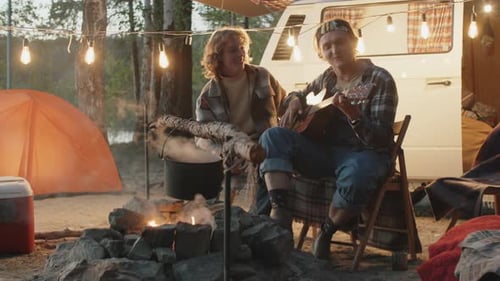 Friends Camping, Playing Guitar by Campfire
