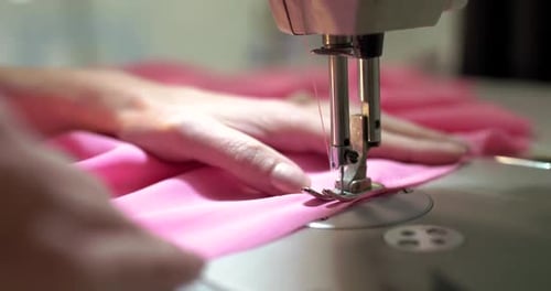 Close View of a Work of Sewing Machine at a Textile Workshop