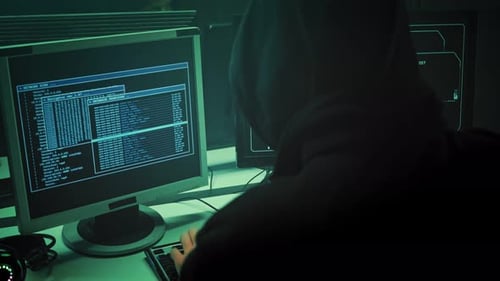 Anonymous Hooded Hacker Programming in Computer Console Breaking Password