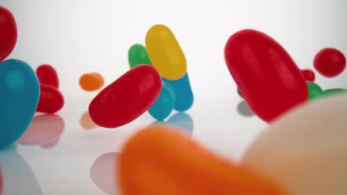 Colorful Jelly Beans Falling onto White Surface