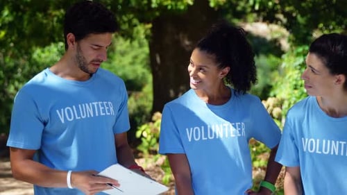 Volunteers discussing with each other in park 4k