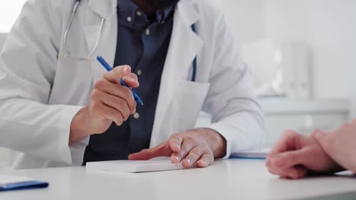Handheld view of doctor writing a prescription. Shot with RED helium camera in 8K