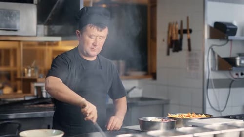 Professional Chef Cooking in Commercial Kitchen