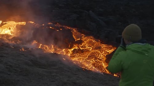Man Photographing Lava Flow From Erupting Fagradalsfjall Volcano In Iceland