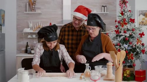 Family Baking Together in Christmas Kitchen