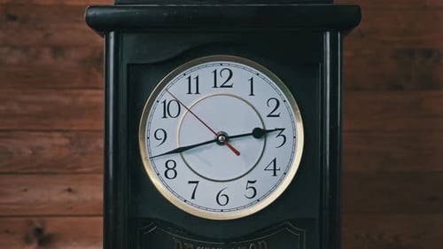 Vintage Wall Clock with Moving Second Hand on Wooden Background