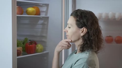 Woman Taking Red Pepper from Refrigerator