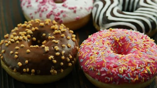 Delicious Donuts with Colorful Toppings on Wooden Surface