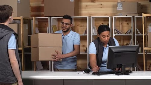 Post Office Clerks Giving Packages to Courier