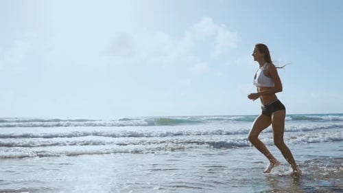 Beautiful Sportive Woman Running Along Beautiful Sandy Beach, Healthy Lifestyle, Enjoying Active