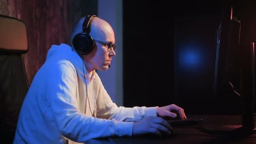 Dedicated Young Man Playing Video Game on Computer